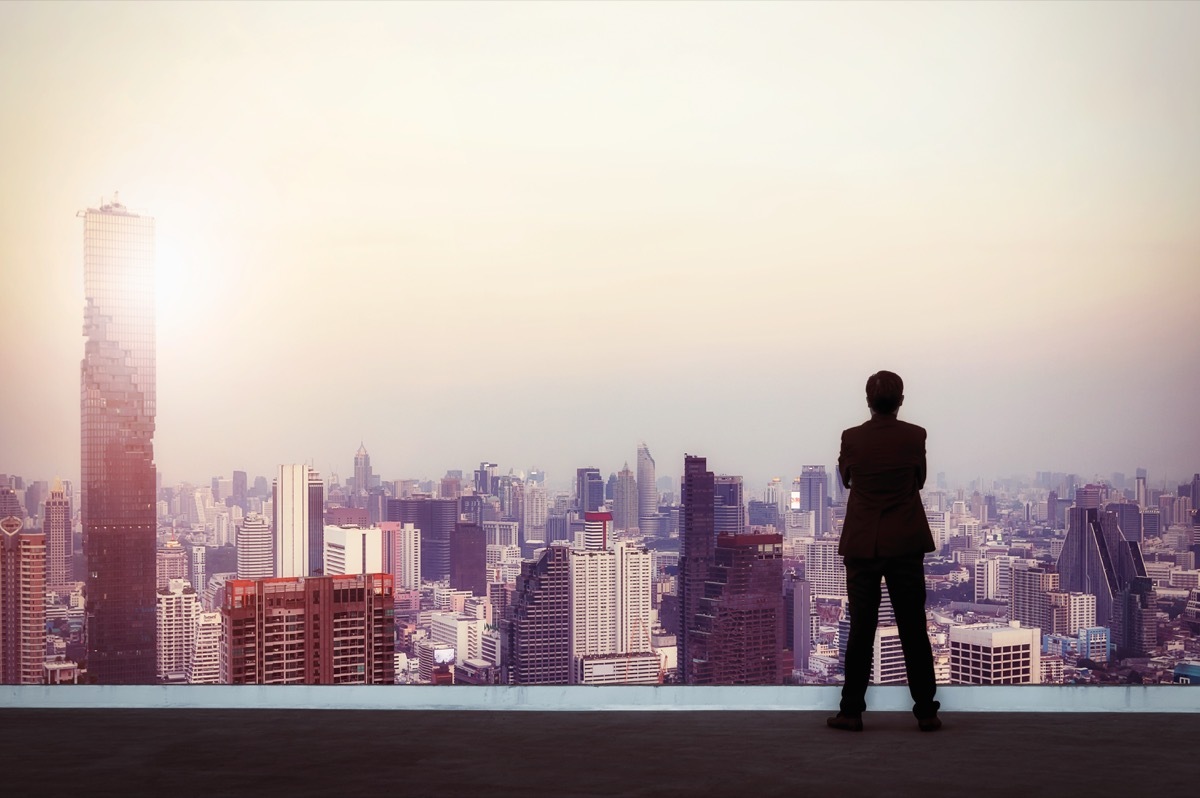 Businessman looking out on city