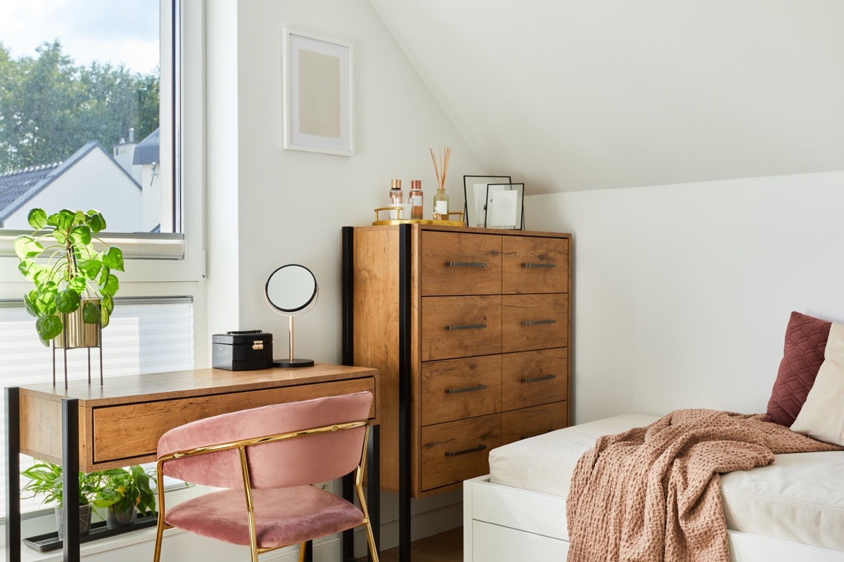 Modern teenage room interior design with bed, table, chest of drawers, pink velvet chair and personal accessories. Template.