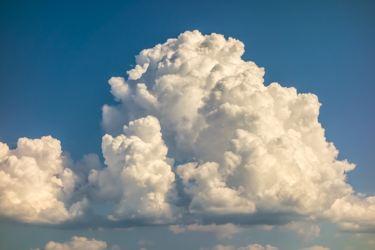 a big and fluffy cumulonimbus cloud in the blue sky