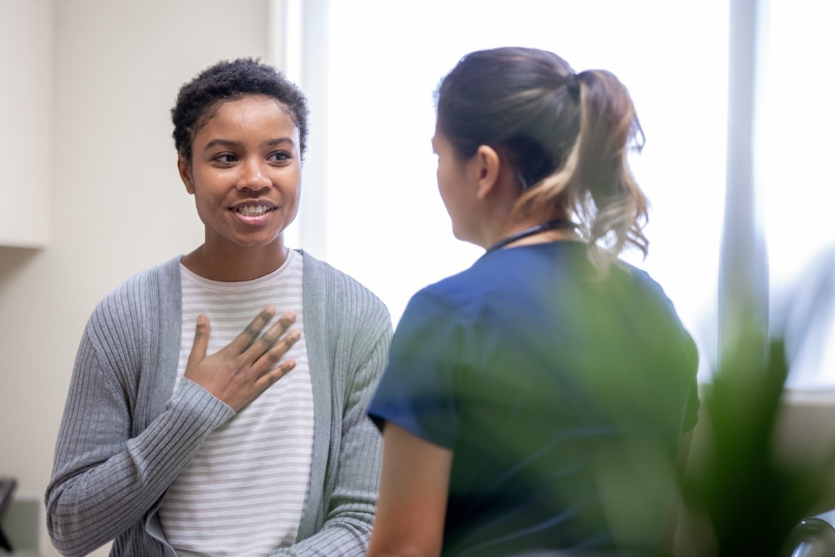 Nurse explaining good news to female patient