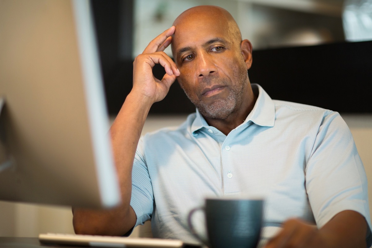 man thinking while being angry and staring off into the distance