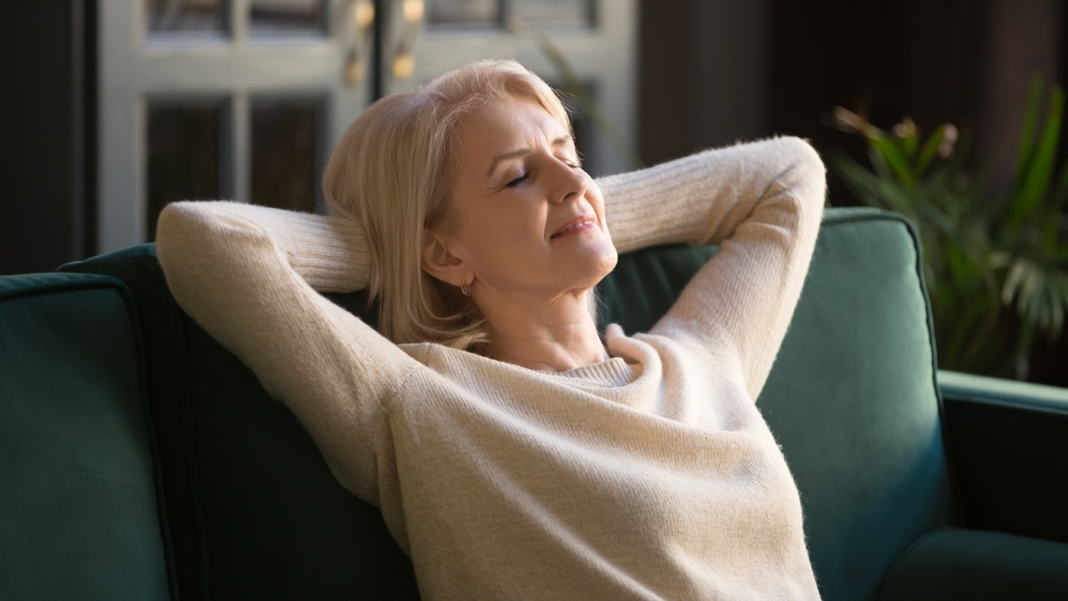 middle aged woman relaxing on couch