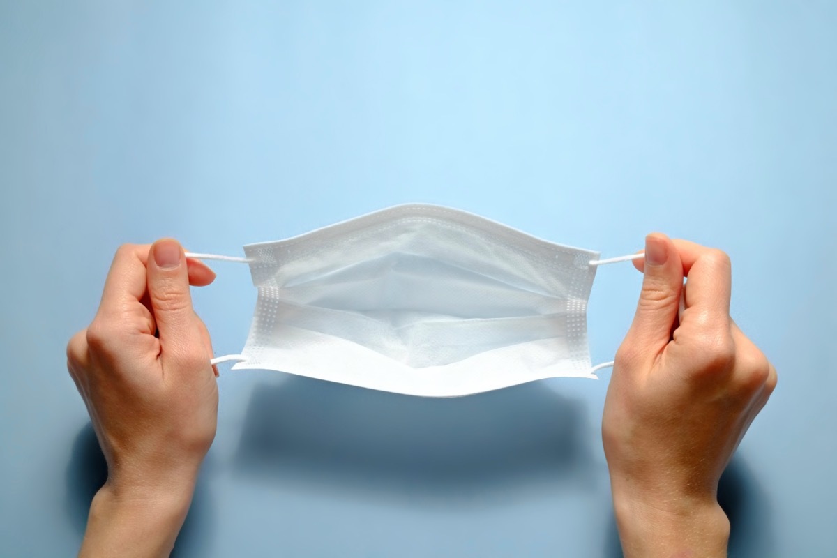 First person view of a woman holding face mask