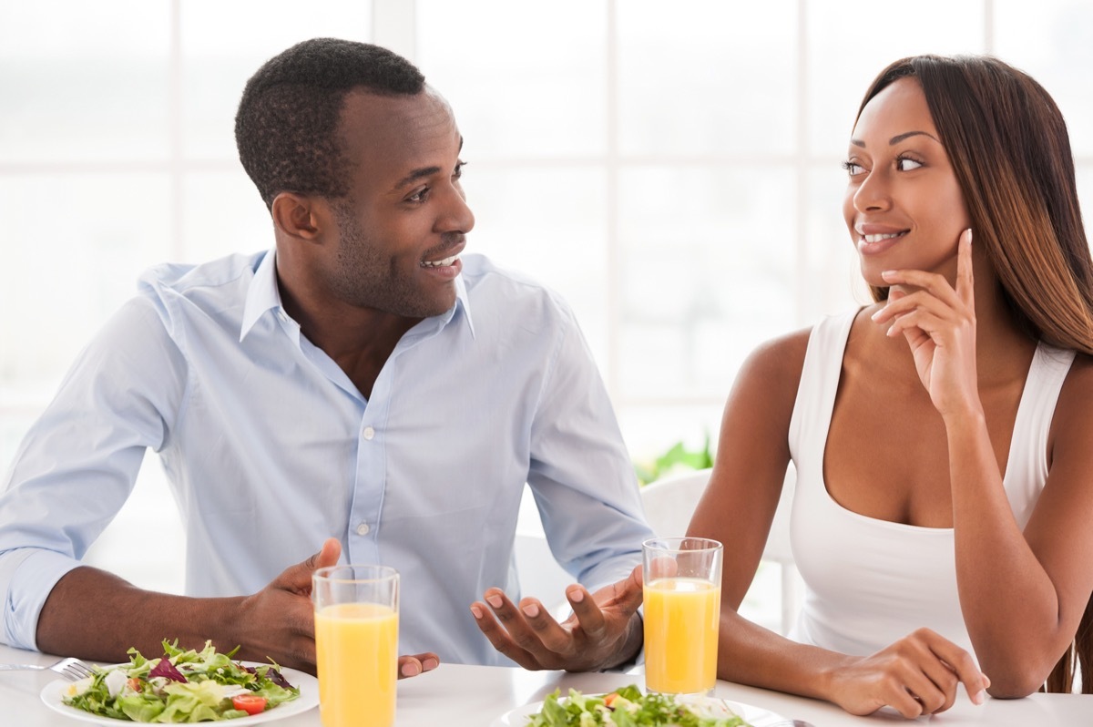 man and woman talking over lunch