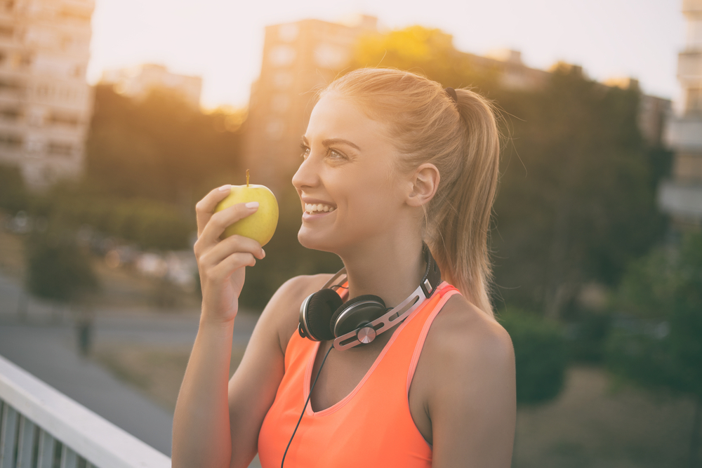 happy healthy woman eating apple.