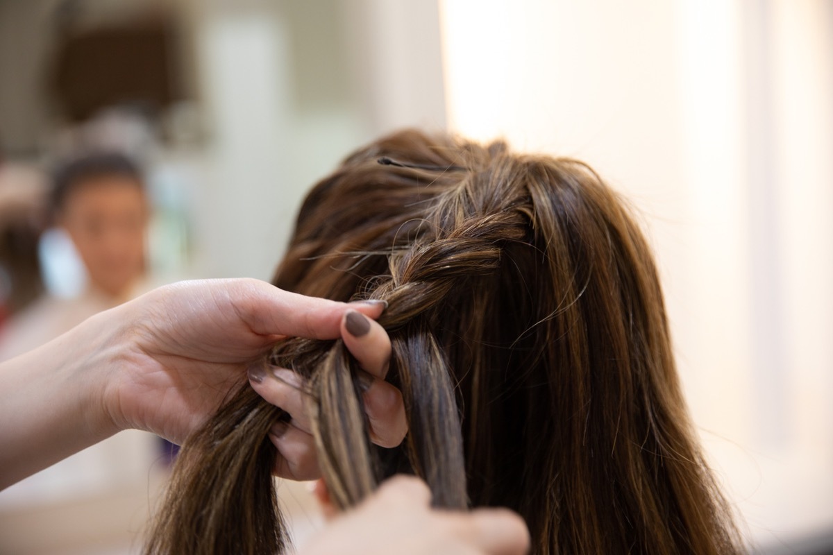 woman having hair done at hair salon