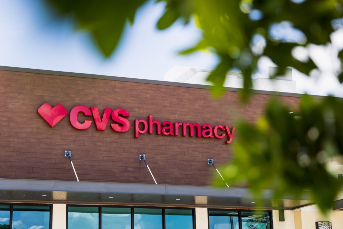 A CVS Pharmacy overlooks an empty parking lot on a hot summer day.