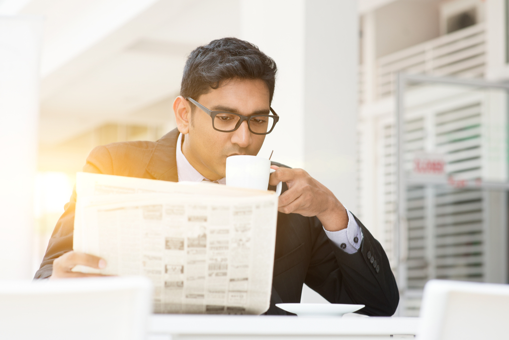 Businessman Reading Newspaper ways to get a promotion after 40