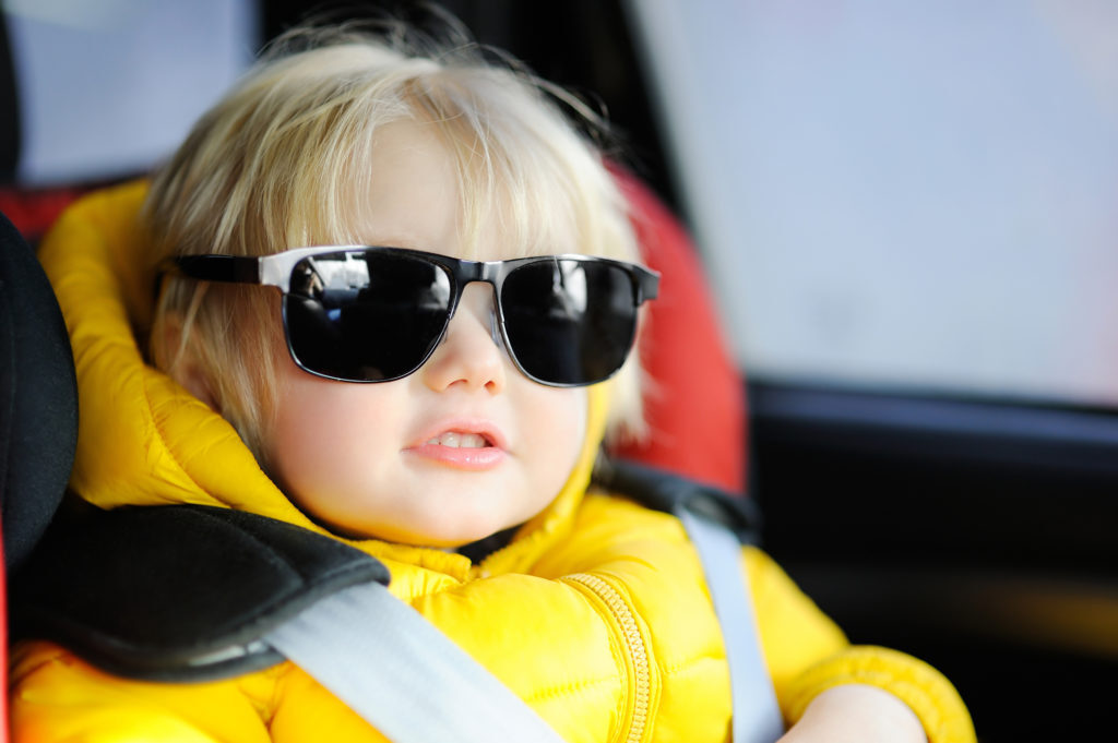 baby sitting in car, looking chill.