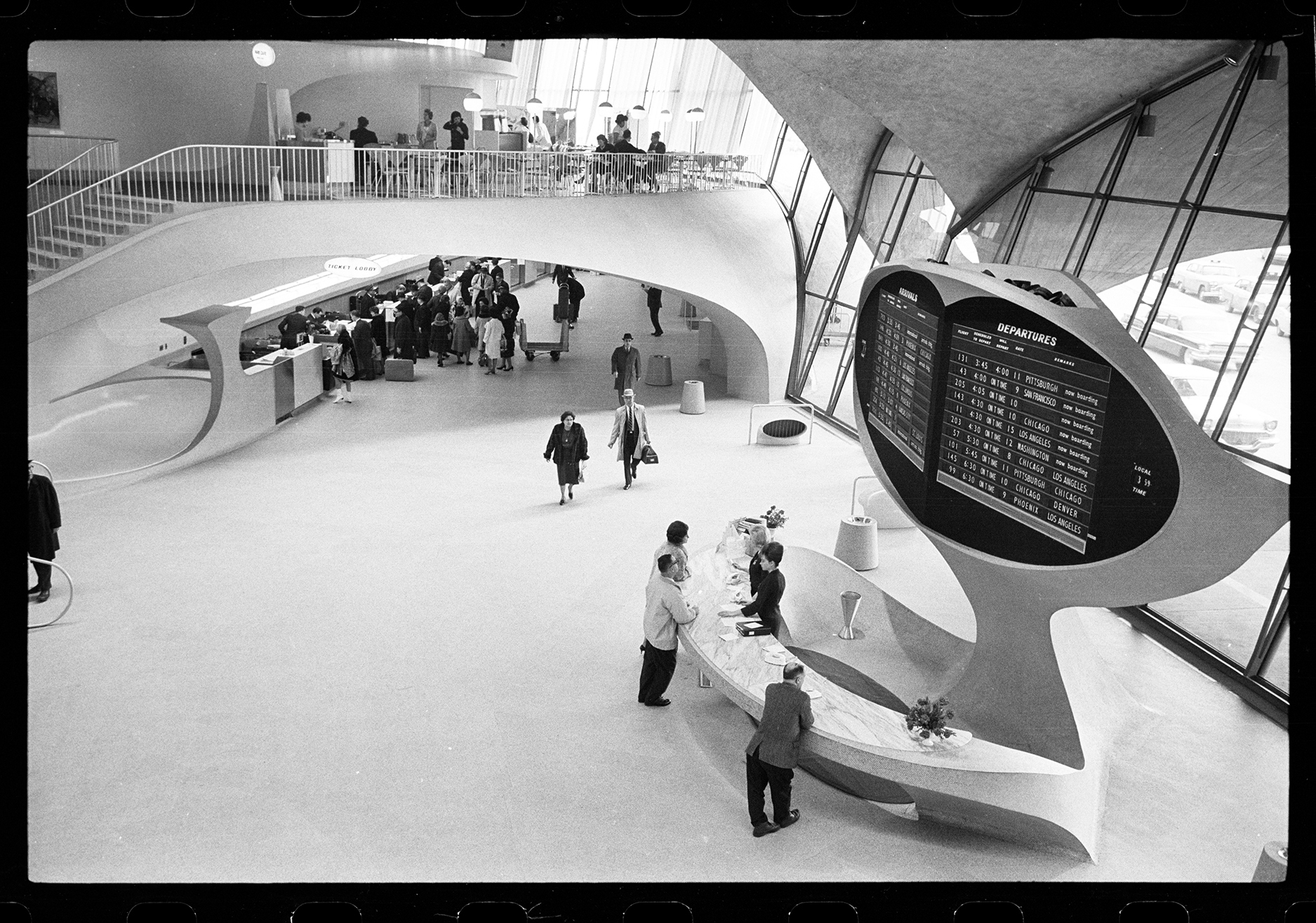 travelers walk through an airport