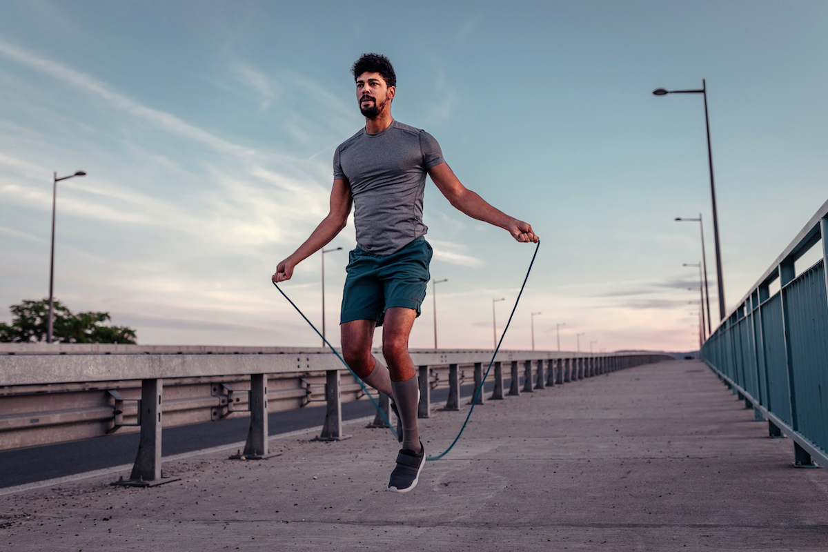 African american athlete man working out on a skipping rope.