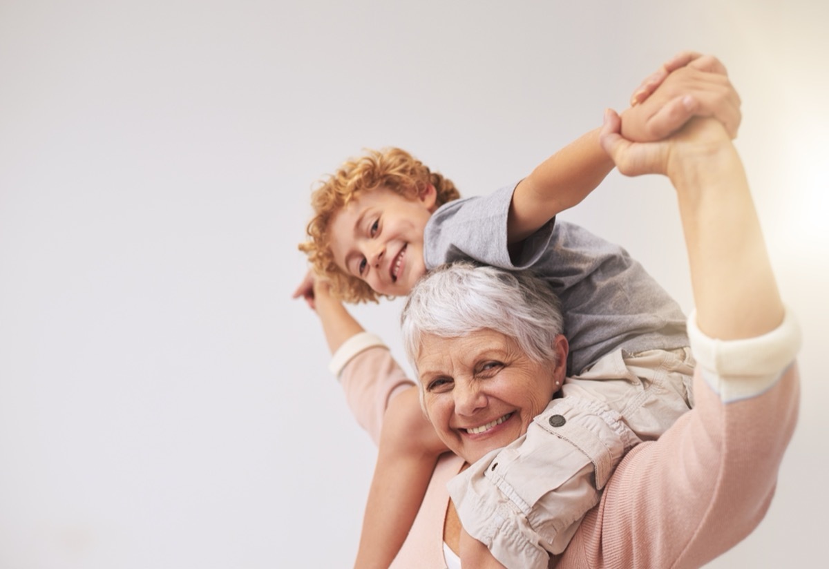 grandma giving her grandson a shoulder ride