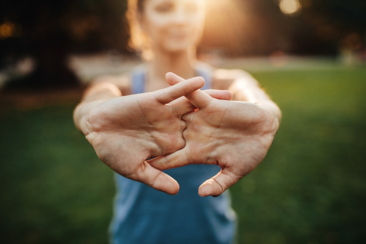 young woman stretching arms