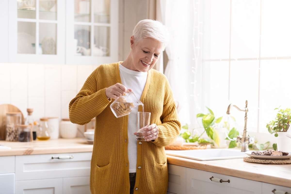 Woman pouring glass of water