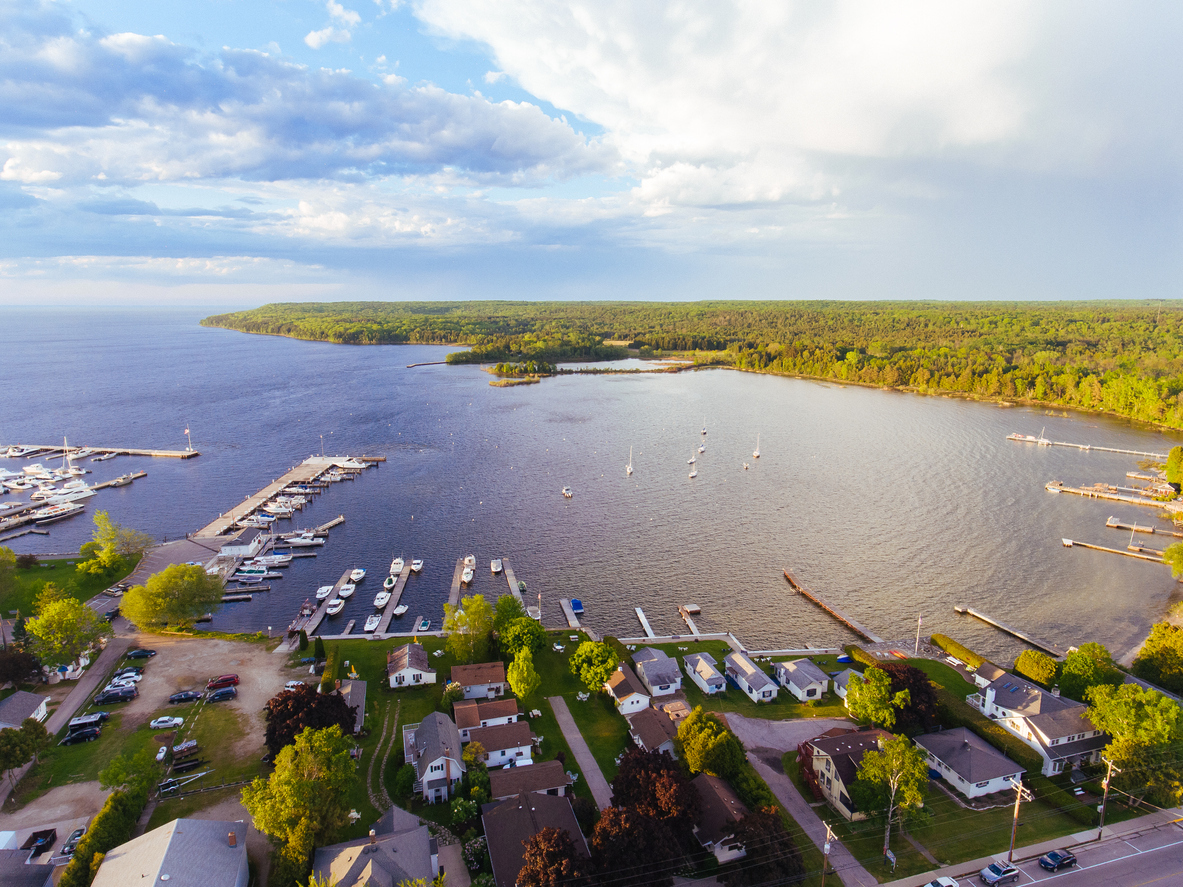 Aerial drone photography showing downtown Fish Creek and its marina, along with Peninsula State Park in Door County, Wisconsin