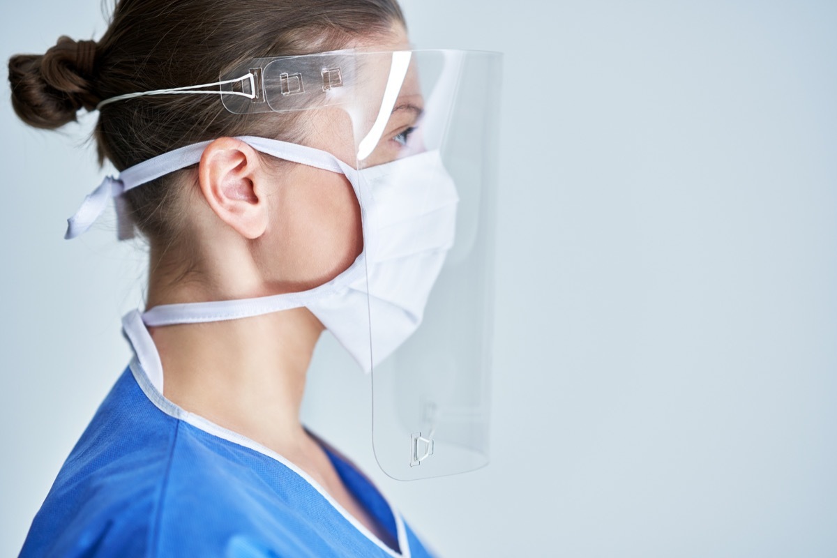 Health care professional wearing face shield and face mask PPE