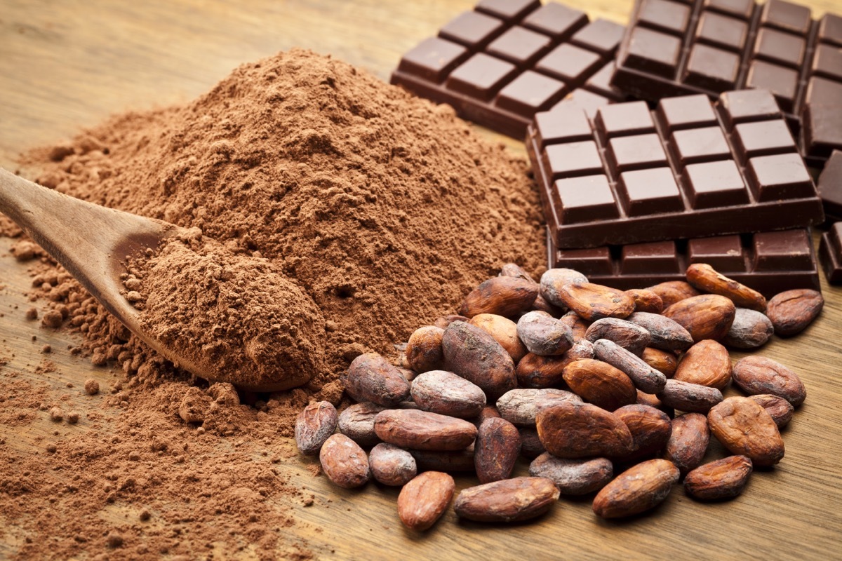 Cocoa Beans and Cocoa Powder with Chocolate Bars on Wood Table.