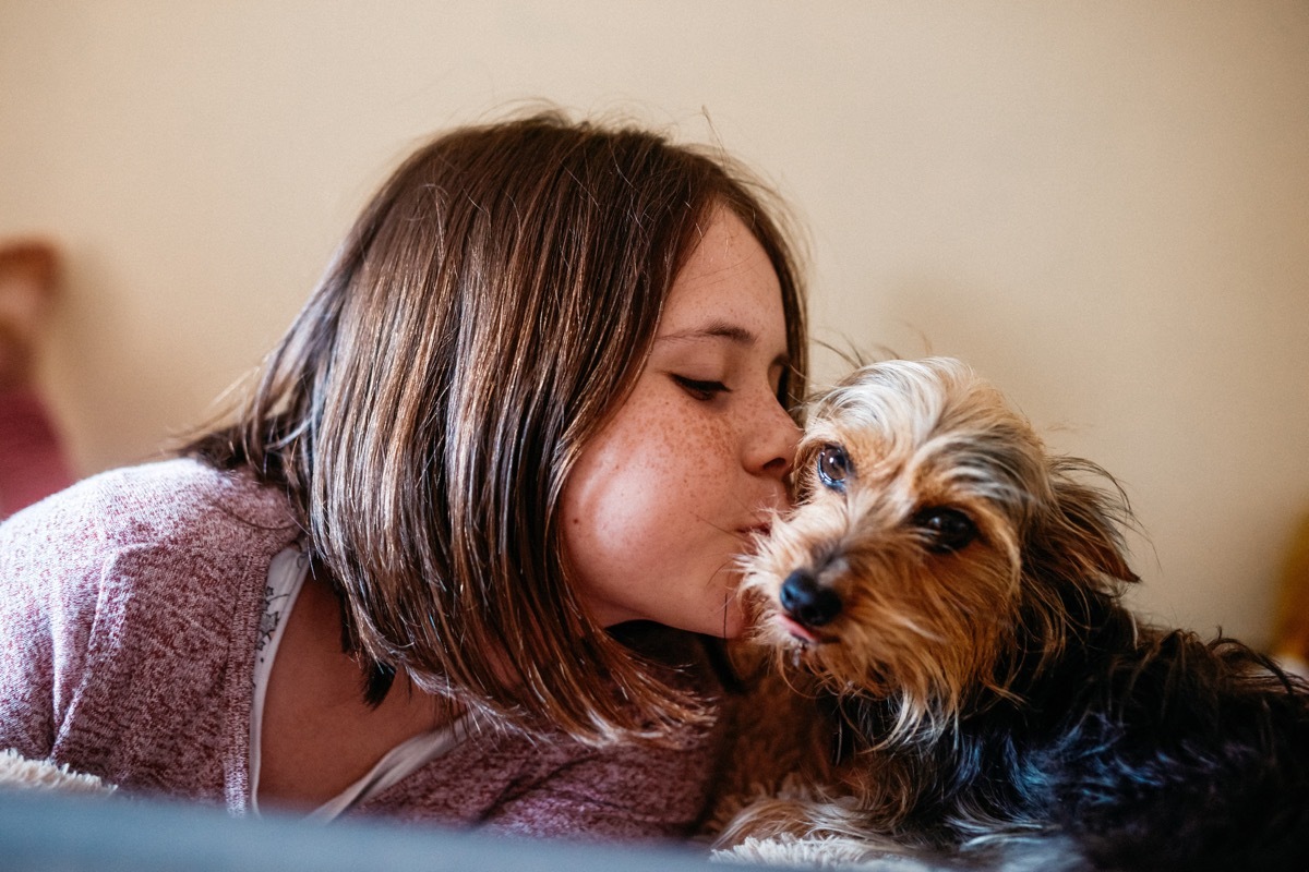 cropped shot of an adorable young girl bonding with her dog