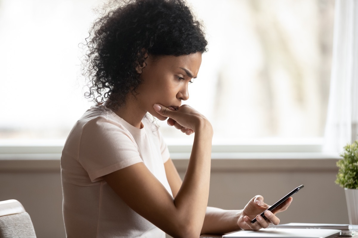 young woman replying to text on smartphone