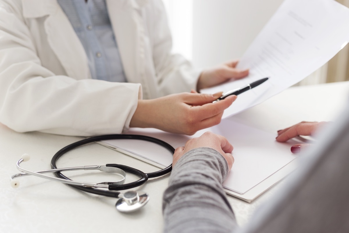 Closeup shot of female doctor writing prescription