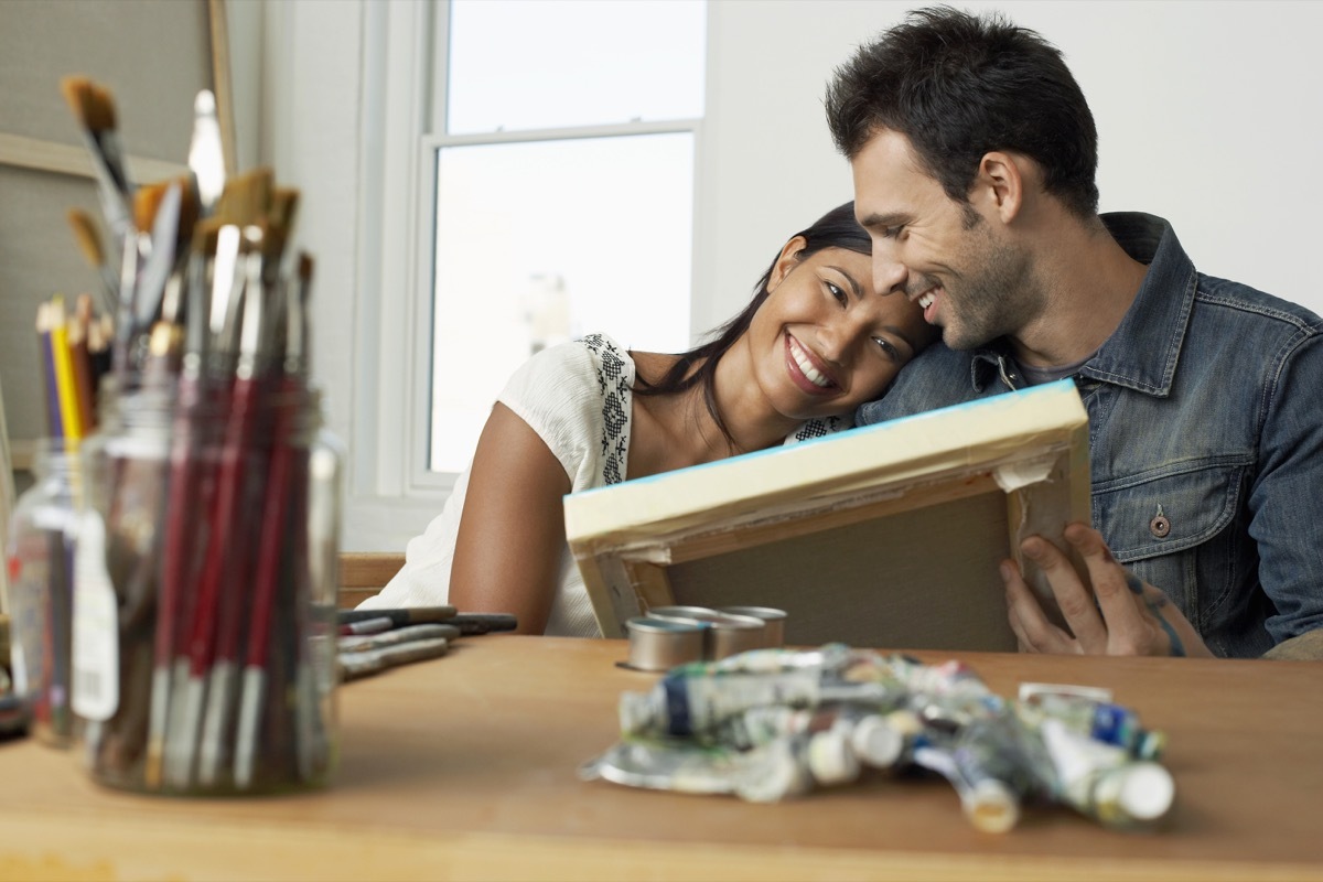 Couple painting together at home