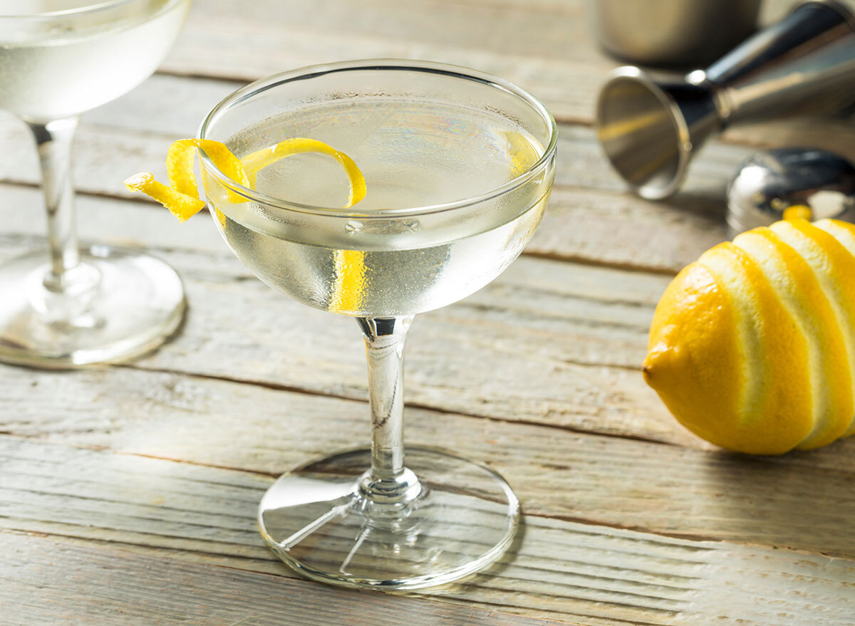 the vesper cocktail in tall glass with lemon peel garnish