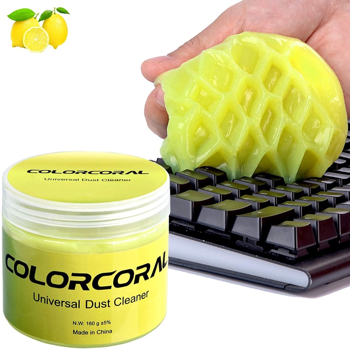 white hand using yellow putty to remove dust from keyboard