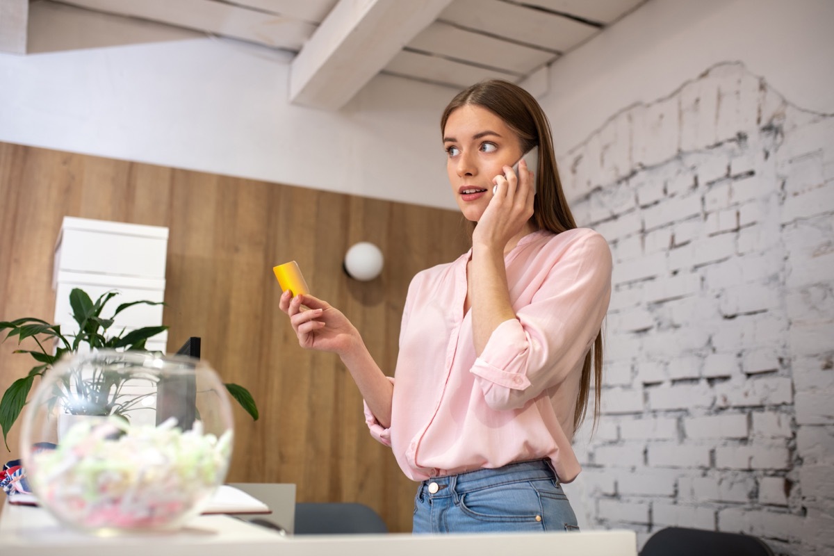 woman calling a child's parent from the school