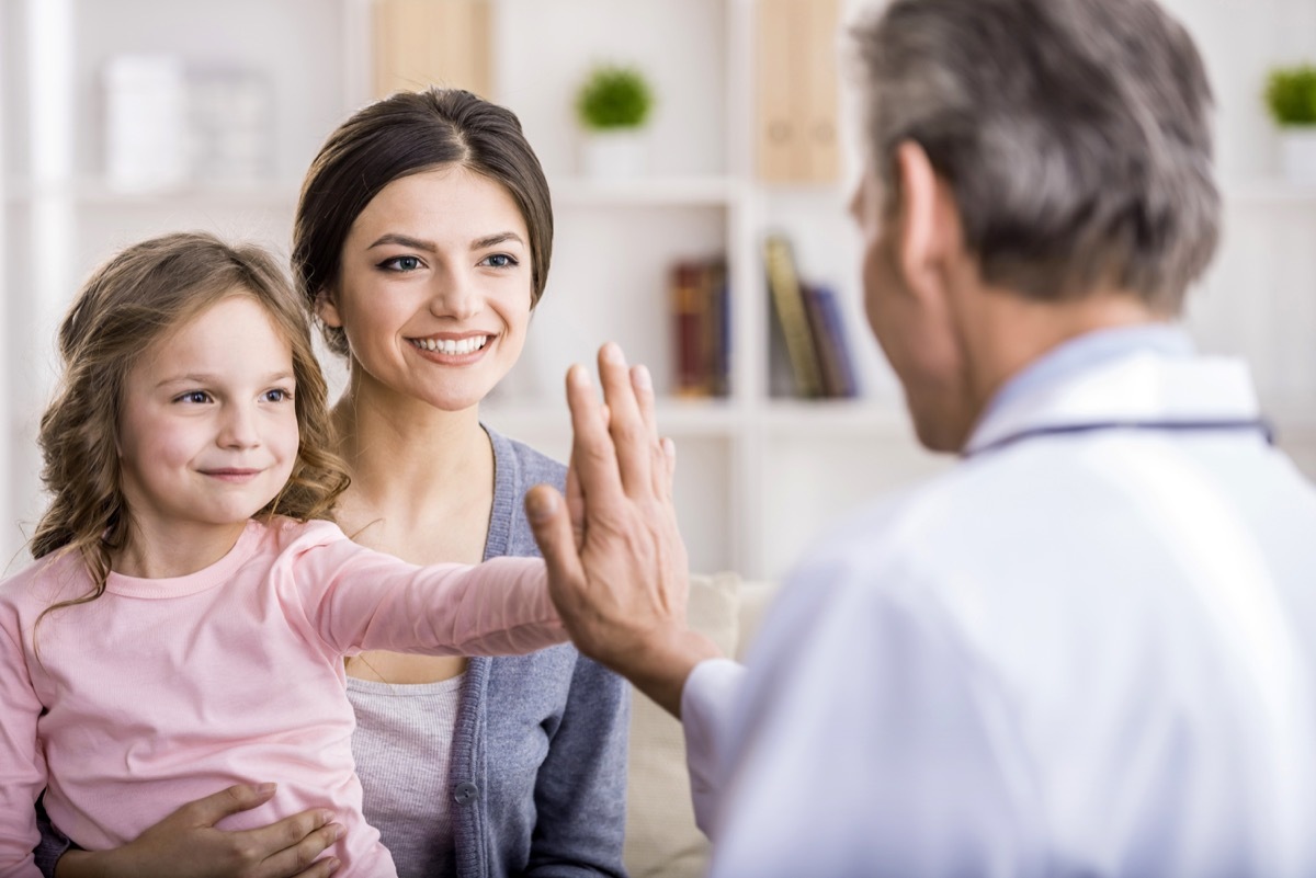 little girl high fiving doctor