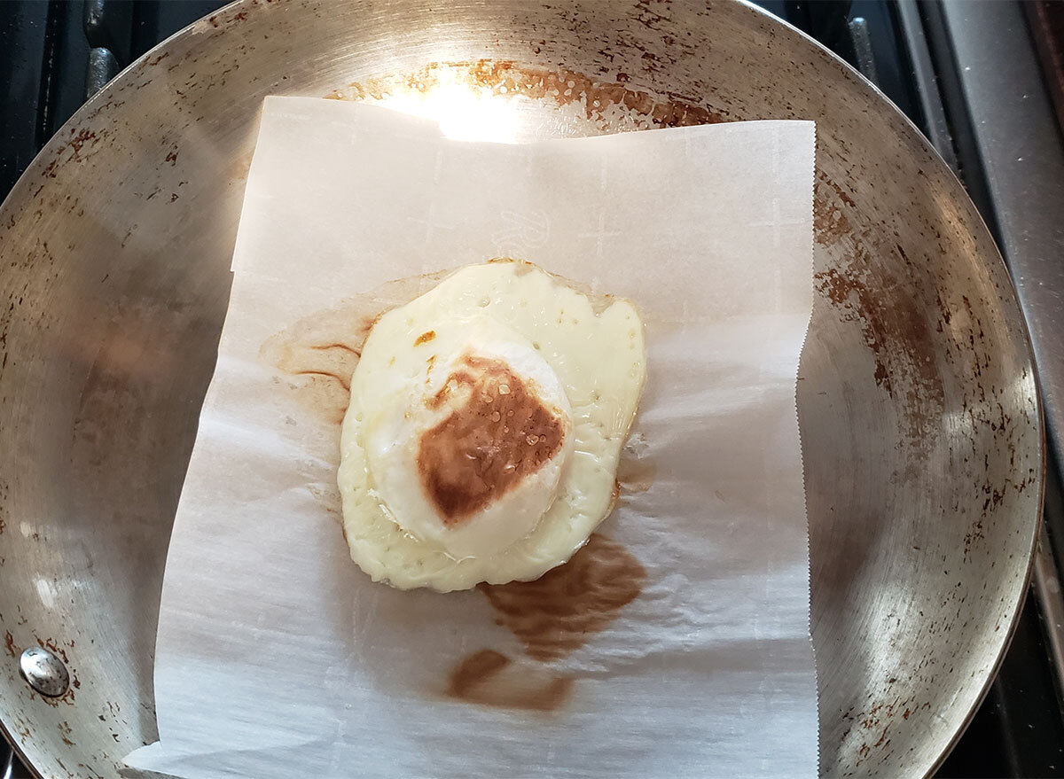 egg on parchment paper in skillet