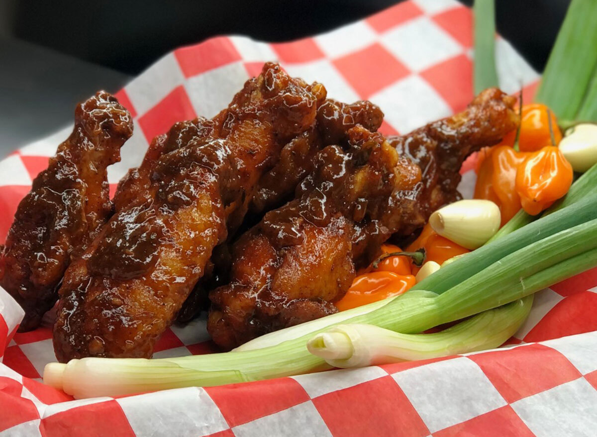 basket of chicken wings with scallions