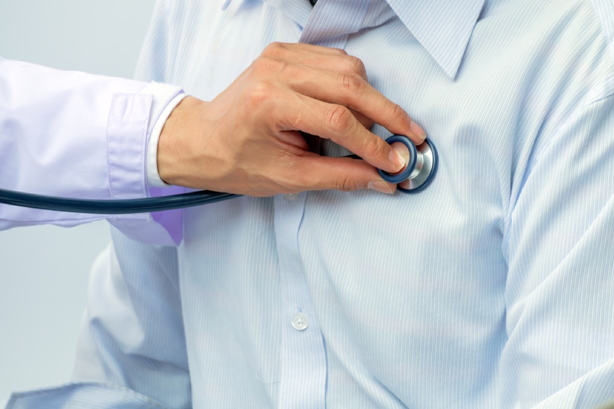 close up of doctor placing stethoscope on patient's chest