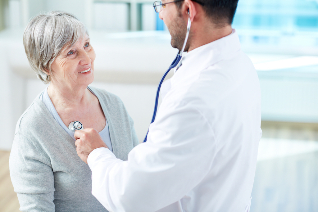 elderly woman talking to male doctor