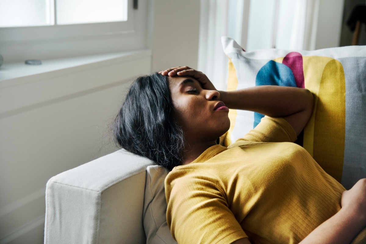 Woman on the couch with a headache