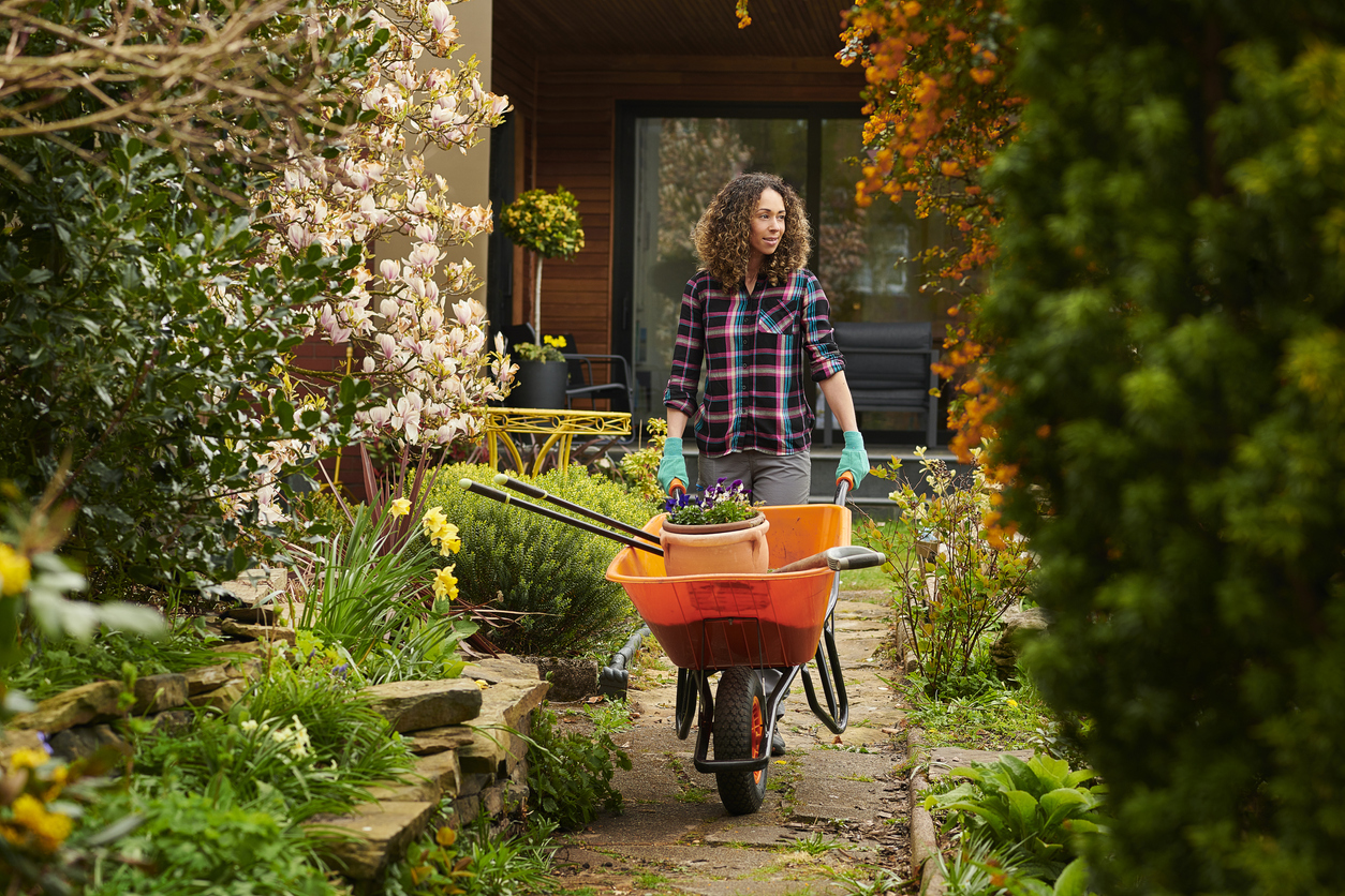 woman taking her tools down the garden