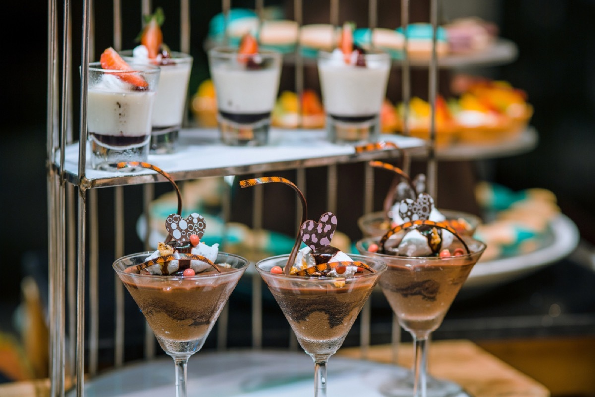 martini glasses full of mousse and ice cream on counter