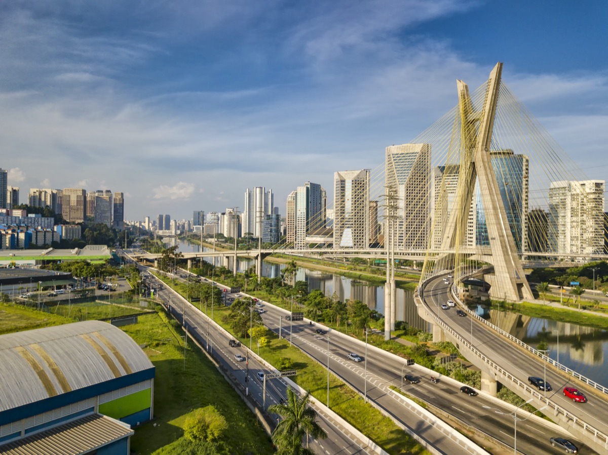 A cable-stayed bridge crosses a river in Sao Paulo