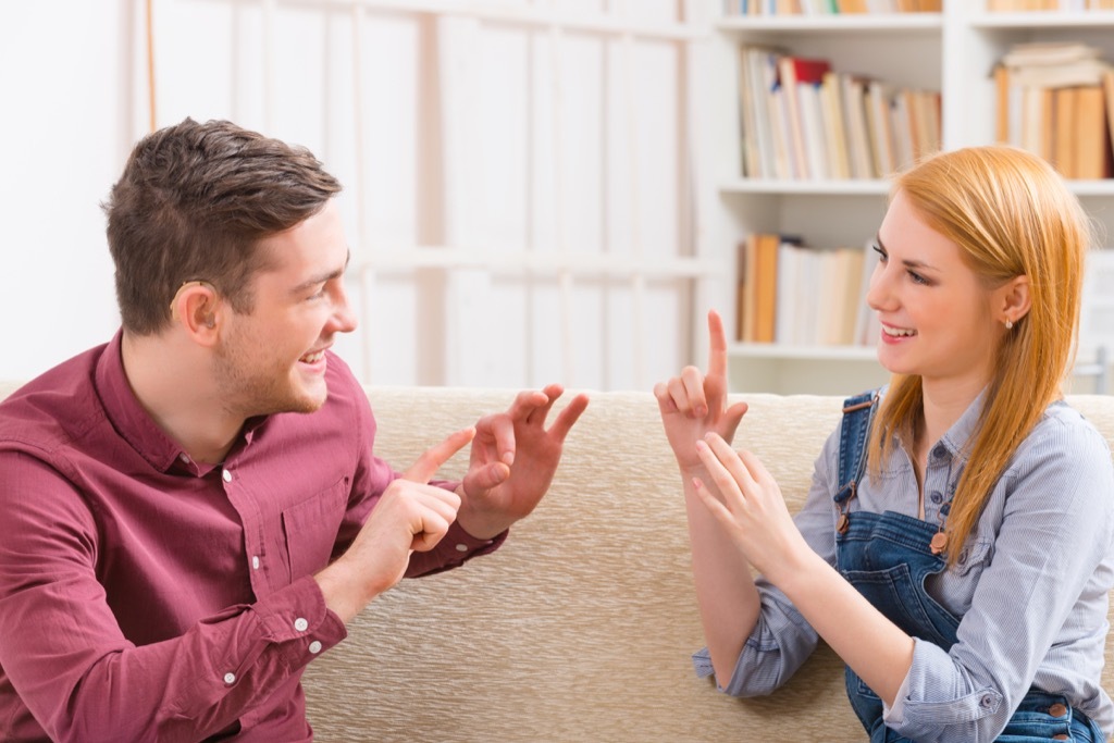 Two people using sign language.