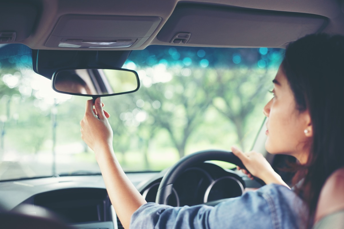 woman concerned rearview mirror