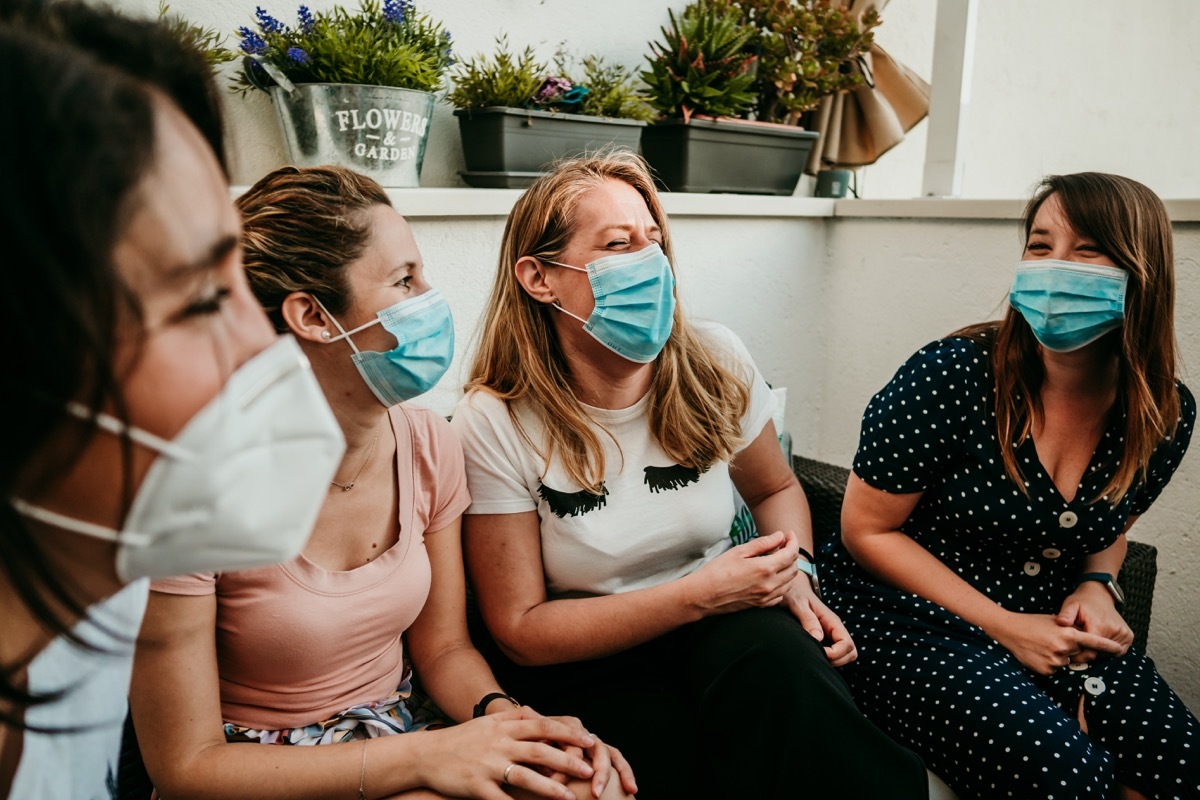 Group of friends hanging out wearing masks with COVID immunity from antibodies