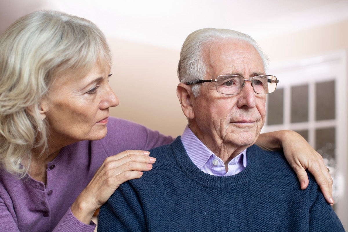 Elderly Man with Dementia Being Comforted by his Wife