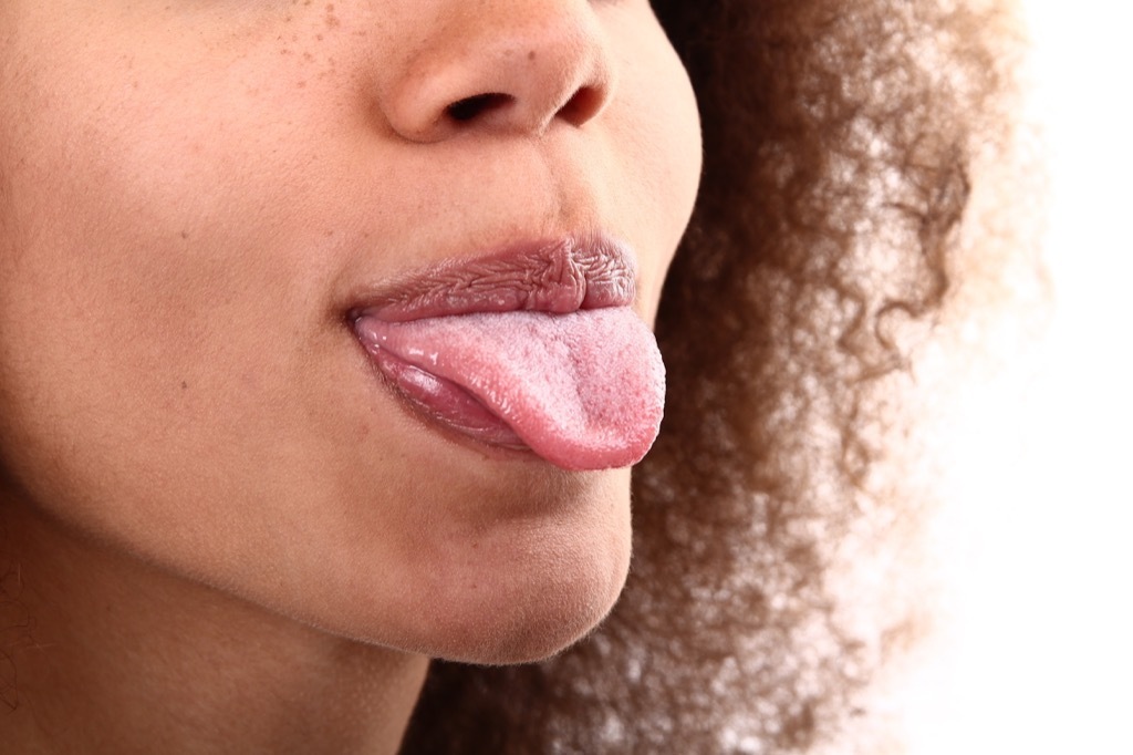 curly haired woman sticking tongue out