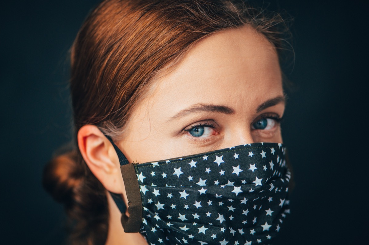 woman wearing star-print face mask in a dark blue or gray