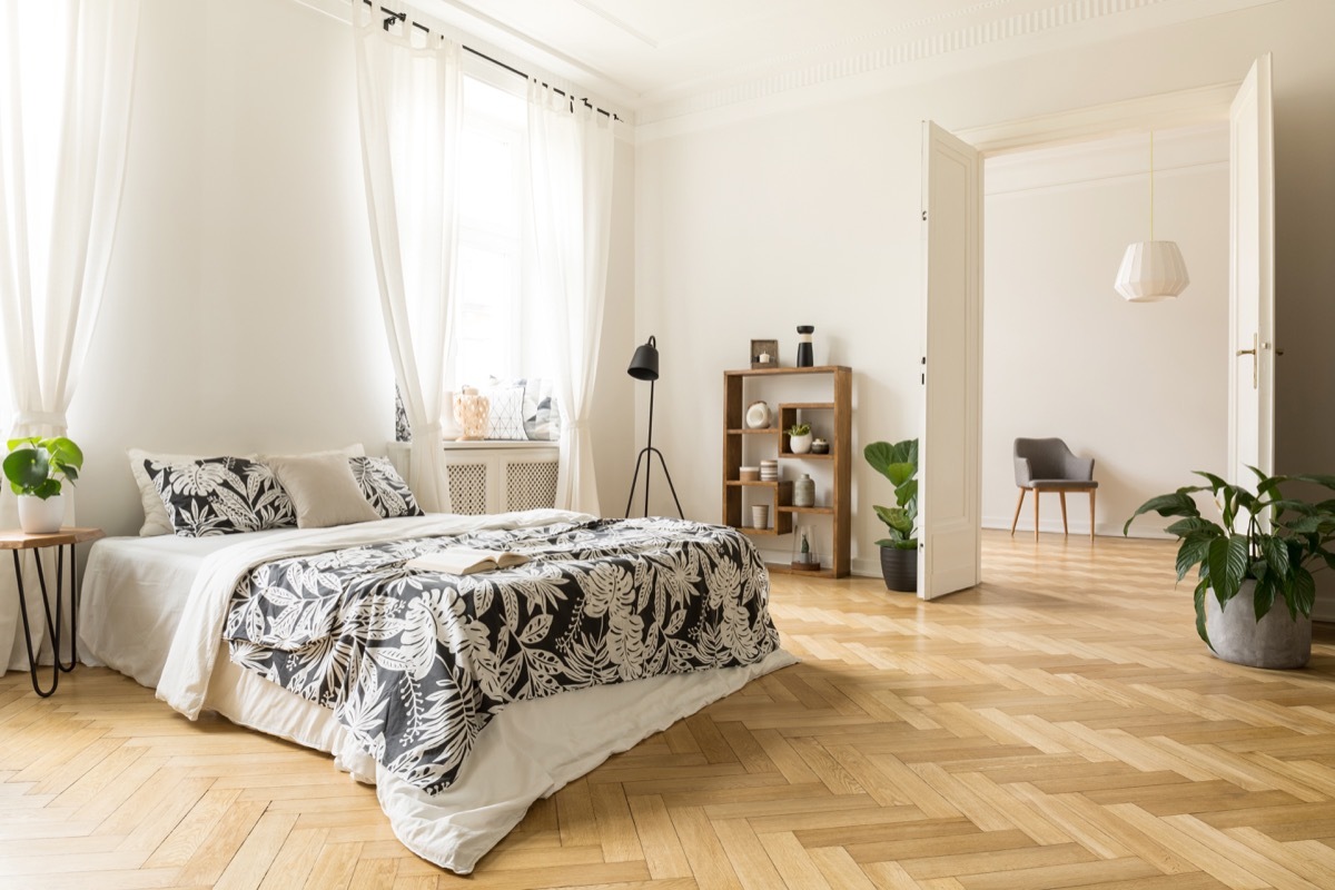 herringbone floor in airy sunny bedroom