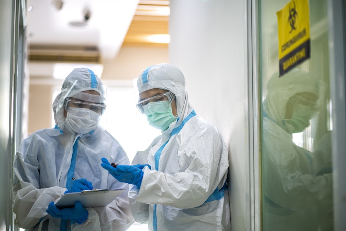 doctor show corona or covid-19 blooding tube wearing ppe suit and face mask in hospital. Corona virus, Covid-19, virus outbreak, medical mask, hospital, quarantine or virus outbreak concept