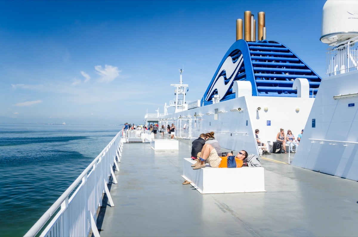 people relaxing outside on cruise with funnels on the side