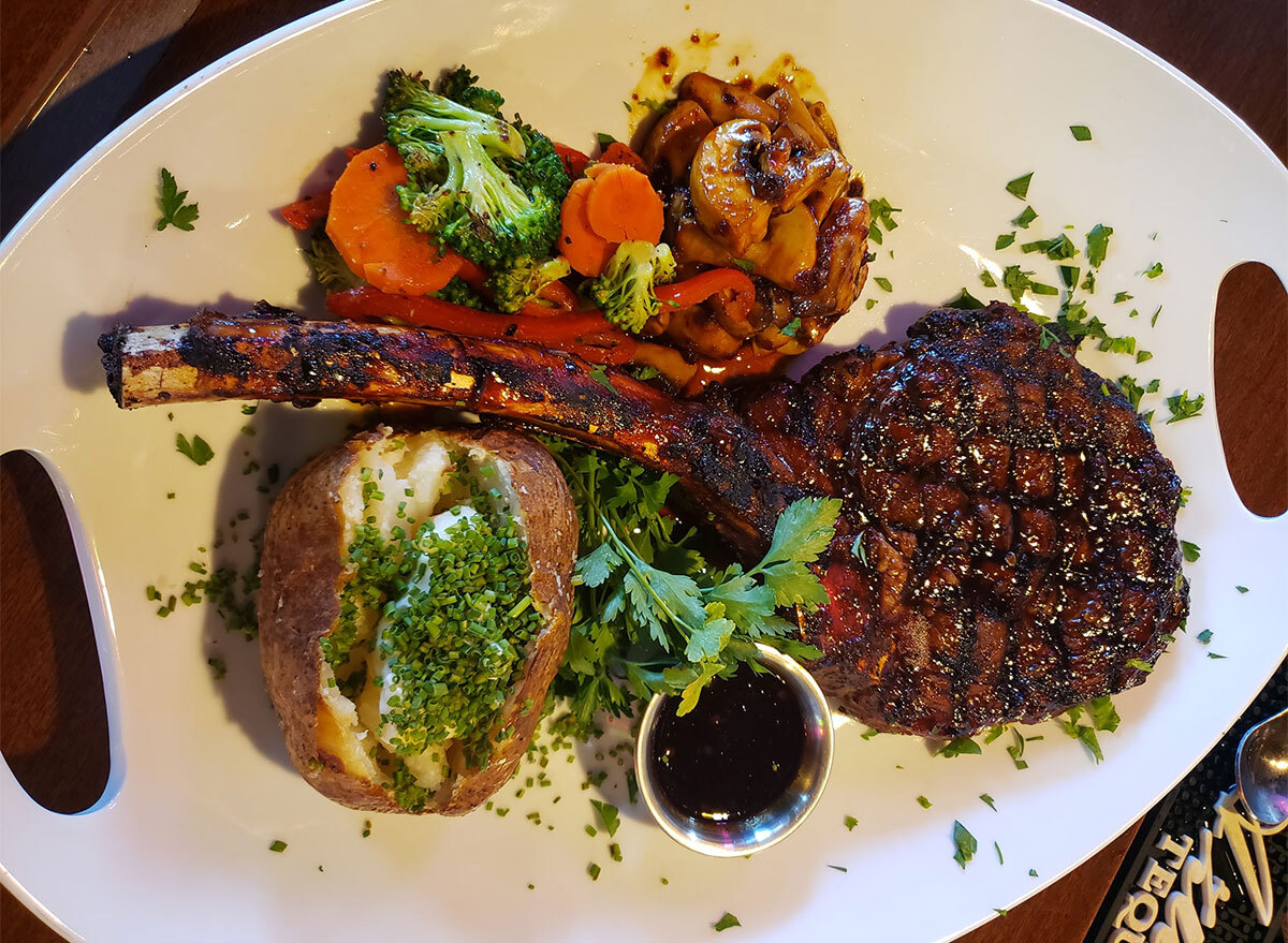 ribeye steak with baked potato on plate