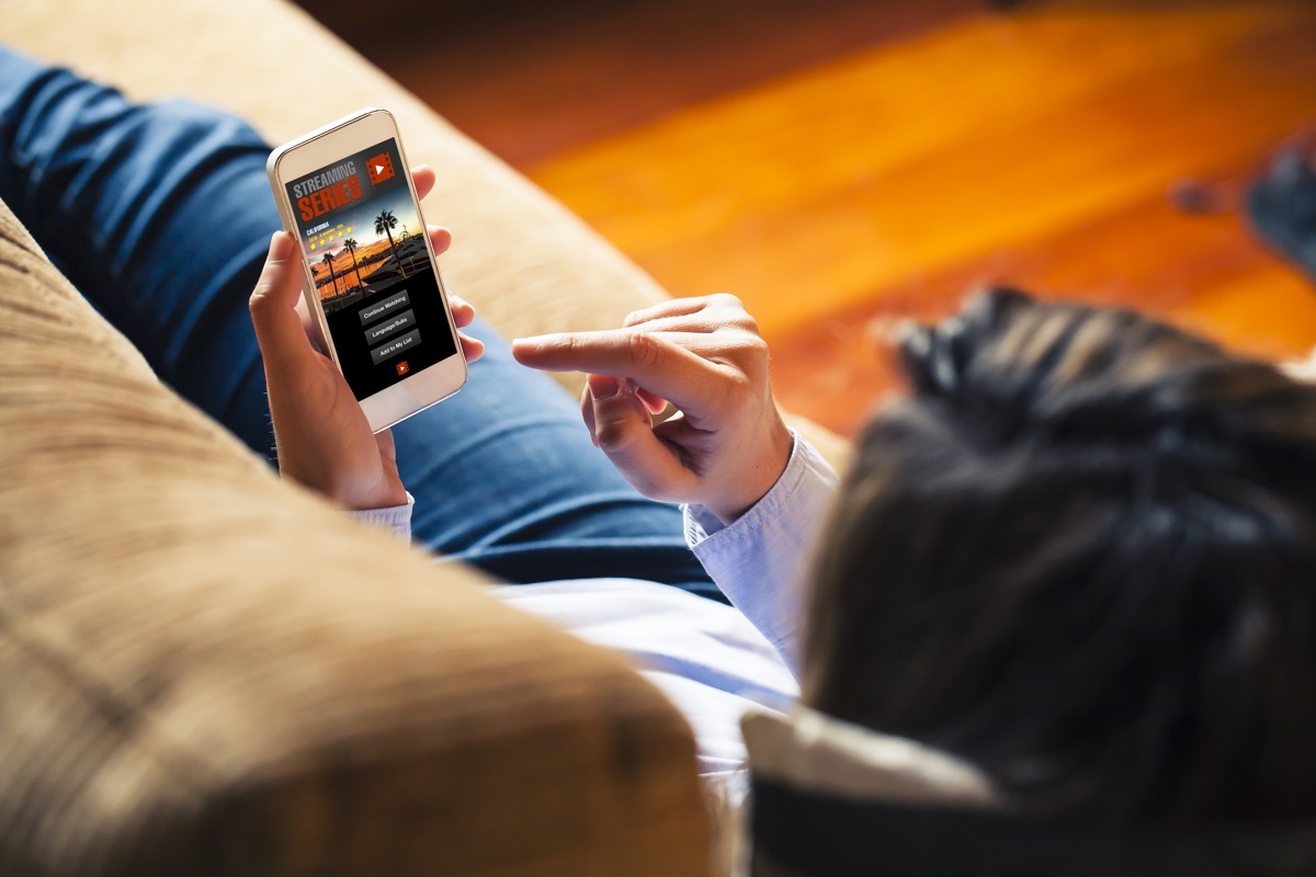 Woman watching streaming service on her phone