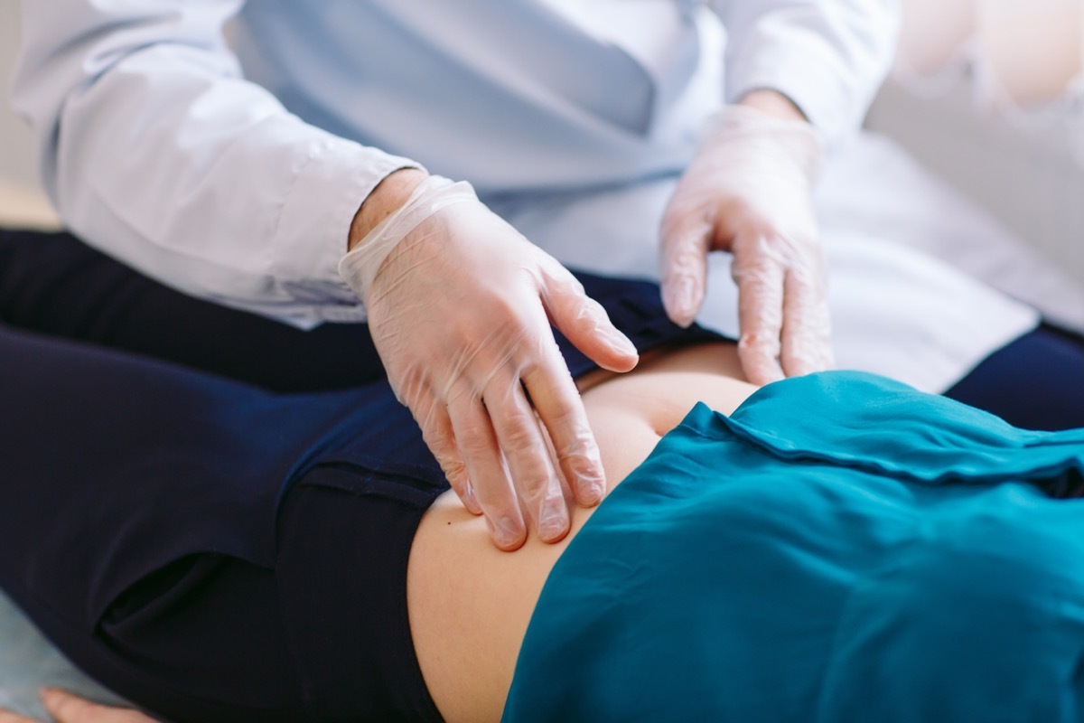 The doctor examines the patient with belly exam.