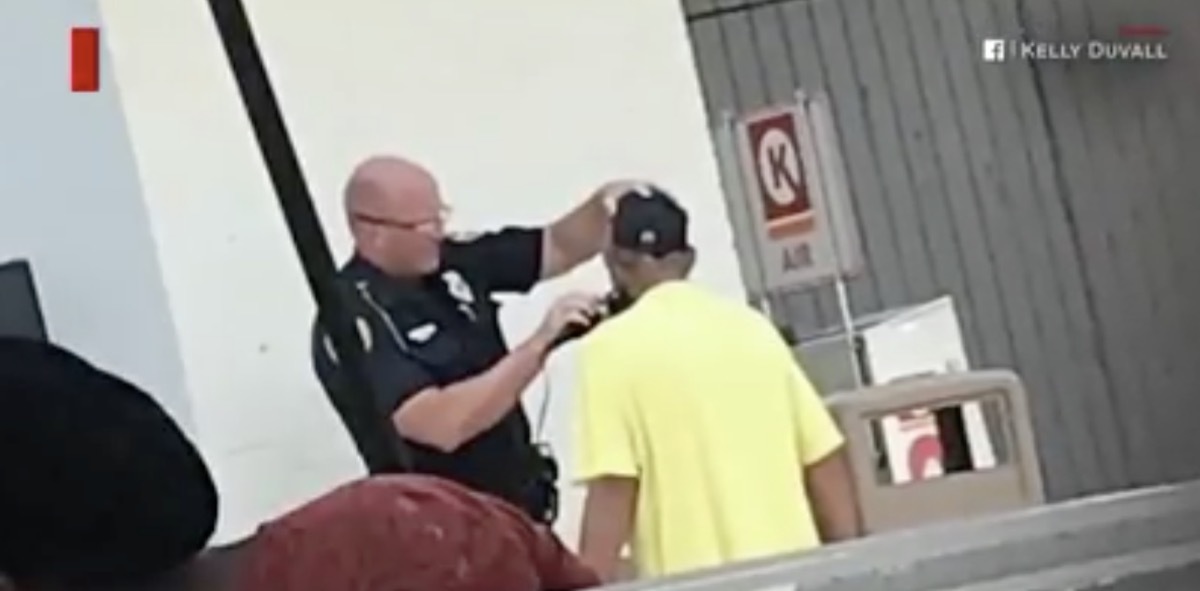 Officer Shaves Mans Face